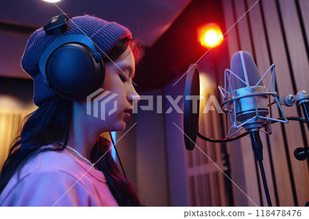 Recording Session with Young Asian Girl Wearing Headphones 118478476