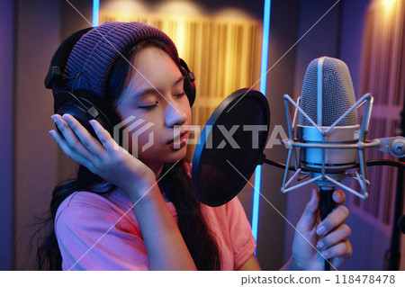 Recording Young Asian Girl Wearing Headphones in Studio Recording Young Asian Girl Wearing Headphones in Studio 118478478