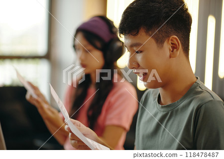 Young Students Engaging in Study Session Indoors Together 118478487