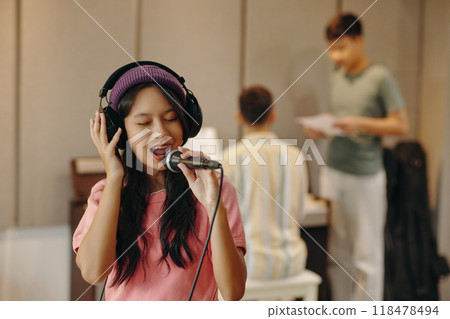 Singing Girl Recording Song in Music Studio 118478494