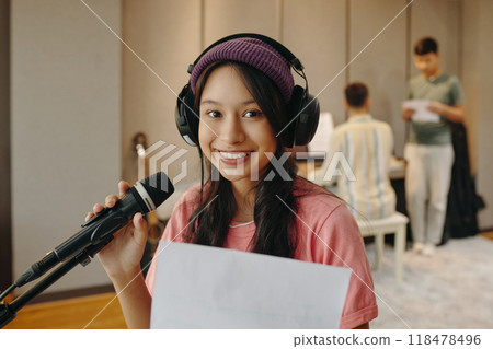 Portrait of Smiling Woman Holding a Microphone 118478496