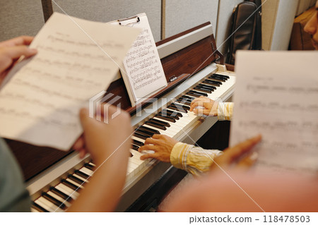 Practicing Music on Piano with Sheet Music Stand 118478503