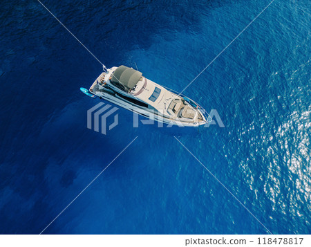 A luxury yacht floating in the middle of deep blue ocean waters 118478817