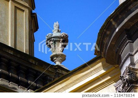 Decorative vase on the belfry of the church made in the Baroque style Element of architecture 118478834