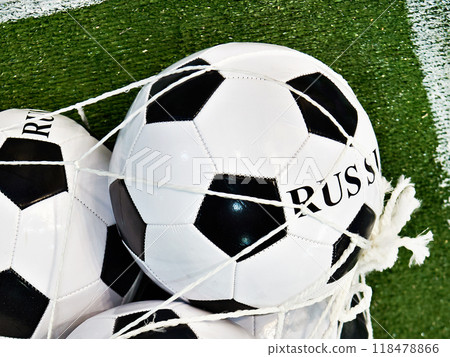Classic soccer balls in grid on green football field lawn Classic soccer balls in grid on green football field lawn 118478866