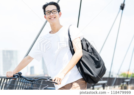 Young man commuting by bicycle Young man commuting by bicycle 118479999