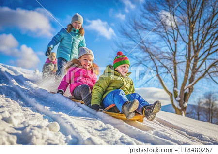 Happy children sledding down a snowy hill Happy children sledding down a snowy hill 118480262