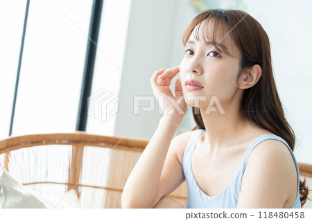 Beauty image of a young woman doing skin care Beauty image of a young woman doing skin care 118480458