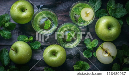 Refreshing green apple drinks garnished with mint leaves on a wooden table 118480987
