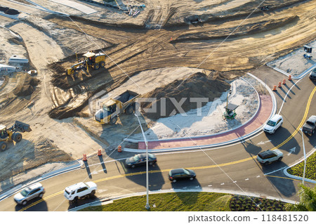 Roadworks construction site at roundabout intersection on American highway. Development of city circular transportation crossroads 118481520