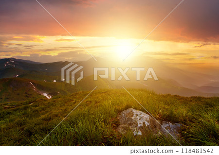 Sunset landscape with green grass meadow, high peaks and foggy valley under vibrant colorful evening sky in rocky mountains. Sunset landscape with green grass meadow, high peaks and foggy valley under vibrant colorful evening sky in rocky mountains. 118481542