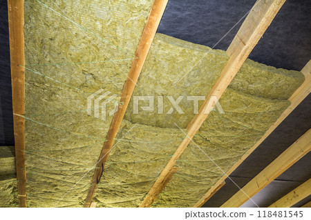 Thermal insulation mineral rock wool installation at the new building attic ceiling 118481545
