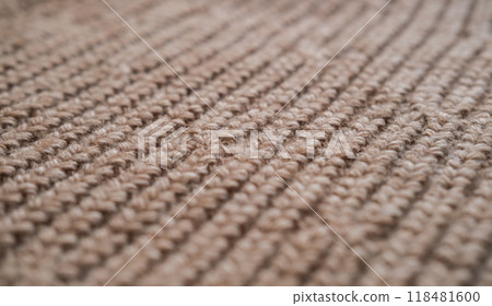 Close-up of the texture of knitted woolen fabric in light brown color 118481600