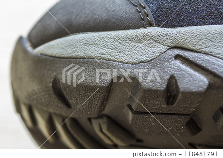 Detail shot of fragmrnt of new fashionable hiking mountain boot. Modern leather trekking footware. Detail shot of fragmrnt of new fashionable hiking mountain boot. Modern leather trekking footware. 118481791