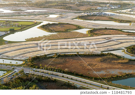 Development of real estate market in the USA. Aerial view of large construction site with building equipment on prepared soil in American rural area Development of real estate market in the USA. Aerial view of large construction site with building equipment on prepared soil in American rural area 118481793