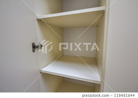 Interior of white plastic cabinet or clothing wardrobe with many empty shelves with open doors. Furniture design and installation. 118481844