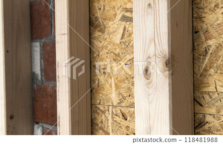 Construction of wood frame walls of a new country house site. Unfinished construction work inside. Construction of wood frame walls of a new country house site. Unfinished construction work inside. 118481988