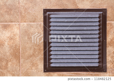 Brown metal industrial panel with ventilation grilles, closeup photo, front view. Detail of architecture design. Air circulation system. 118482125