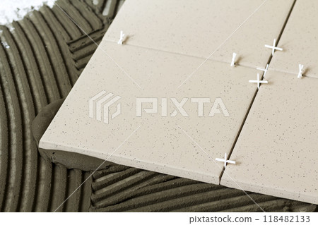 Ceramic tiles and tools for tiler. Floor tiles installation. Home improvement, renovation - ceramic tile floor adhesive Ceramic tiles and tools for tiler. Floor tiles installation. Home improvement, renovation - ceramic tile floor adhesive 118482133