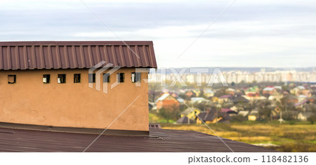 Chimney on a roof of a new built house with view of a city below Chimney on a roof of a new built house with view of a city below 118482136