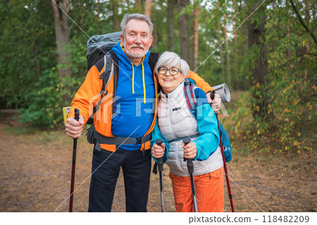 Hiking tourism adventure. Senior couple man woman enjoying outdoor recreation hiking in forest. Happy old people backpackers hikers enjoy walking hike trekking tourism active vacation beauty of nature Hiking tourism adventure. Senior couple man woman enjoying outdoor recreation hiking in forest. Happy old people backpackers hikers enjoy walking hike trekking tourism active vacation beauty of nature 118482209