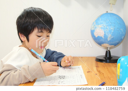 A boy studying 118482759