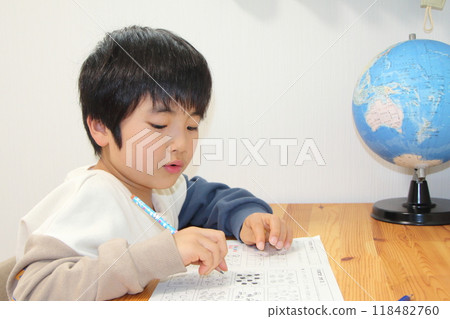 A boy studying 118482760