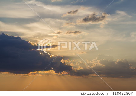 Panorama of sky at sunrise or sunset. Beautiful view of dark blue clouds lit by bright orange yellow sun on clear sky. Beauty and power of nature, meteorology and climate changing concept. Panorama of sky at sunrise or sunset. Beautiful view of dark blue clouds lit by bright orange yellow sun on clear sky. Beauty and power of nature, meteorology and climate changing concept. 118482807