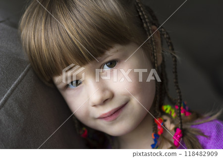 Portrait of pretty little girl with small braids 118482909