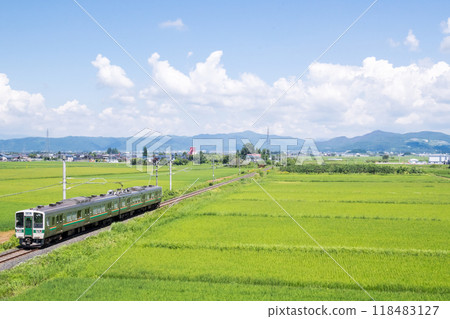 [Yamagata Line] A local train running through a rural landscape 118483127