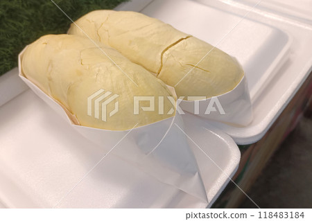 closeup two yellow monthong durians fruit is wrapped in white paper and placed on foam, on the green grass floor background, fruit, thailand fruit, food, sweet, copy space 118483184