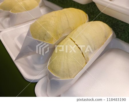 yellow monthong durians fruit is wrapped in white paper and placed on foam, on the green grass floor background, fruit, thailand fruit, food, sweet, delicious 118483190