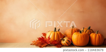 Simple autumn display with orange pumpkins and red leaves on a beige background. Ideal for fall decorations, Thanksgiving themes, and harvest season visuals 118483678