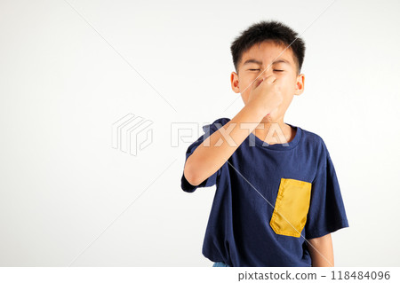 Asian young child unhappy what a smell disgust expression squeezing nose with fingers. Kid boy primary have something stinks bad smell situation, studio shot isolated on white background, Healthcare Asian young child unhappy what a smell disgust expression squeezing nose with fingers. Kid boy primary have something stinks bad smell situation, studio shot isolated on white background, Healthcare 118484096