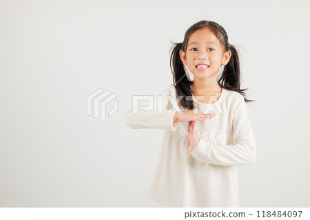 Closeup portrait young kid girl smiling making give time out gesture with hands studio shot isolated on white background, kindergarten child demonstrates break hand sign, stop time with copy space Closeup portrait young kid girl smiling making give time out gesture with hands studio shot isolated on white background, kindergarten child demonstrates break hand sign, stop time with copy space 118484097