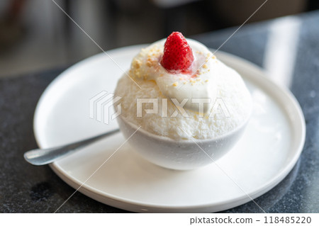 Shaved ice or Bingsu with strawberry on top, served in a bowl Shaved ice or Bingsu with strawberry on top, served in a bowl 118485220