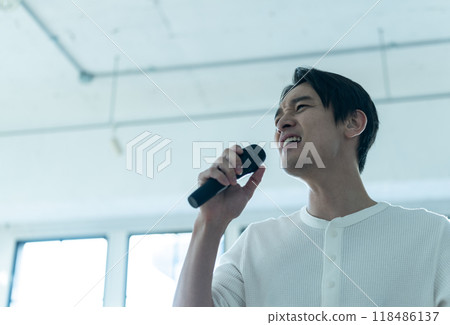Male hand holding a microphone Male hand holding a microphone 118486137
