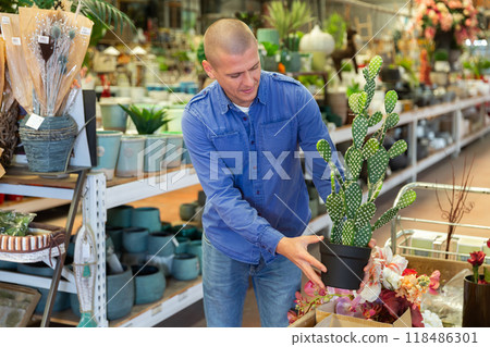 Man purchasing replica of cactus in store 118486301