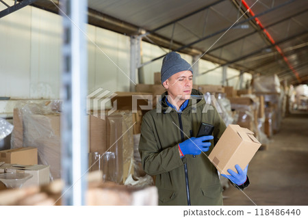Fulfillment center worker using smartphone in his work 118486440