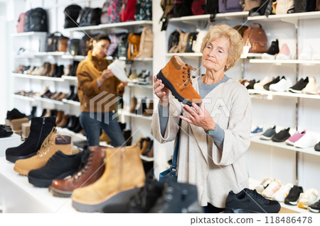 Old and younger women making purchases in shoeshop Old and younger women making purchases in shoeshop 118486478