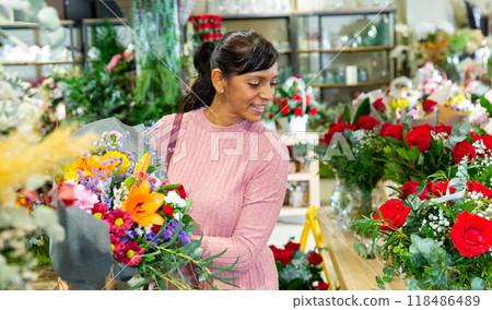 Portrait of a latin american woman choosing a bouquet of flowers Portrait of a latin american woman choosing a bouquet of flowers 118486489