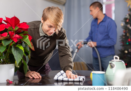 Son helps his father to clean room before christmas Son helps his father to clean room before christmas 118486490