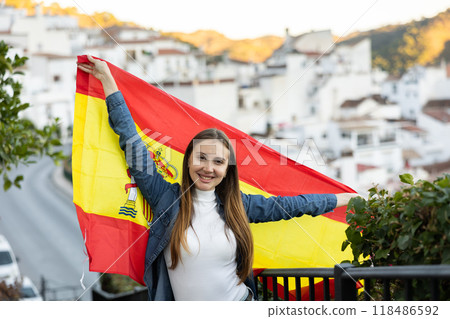 Hapy footbal fan woman waving the flag of Spain on street 118486592