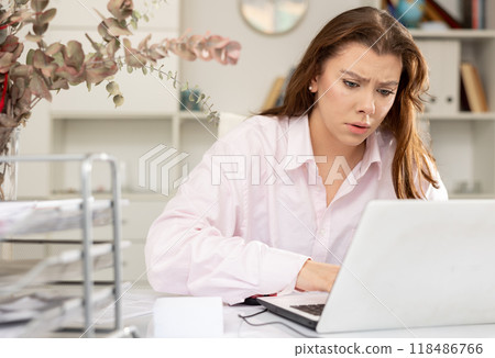 Tired young businesswoman working with documents Tired young businesswoman working with documents 118486766
