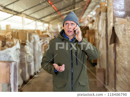 Storekeeper having telephone conversation during working day Storekeeper having telephone conversation during working day 118486790