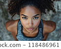 Portrait of a determined fitness enthusiast wearing workout clothes and sporting a focused expression ready to tackle their fitness goals and wellness routine with passion and discipline 118486961