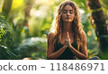 A young woman in a peaceful meadow surrounded by lush greenery is practicing yoga and finding inner calm and balance The serene outdoor setting promotes relaxation wellness 118486971