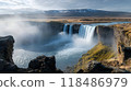 Powerful waterfall cascading down a majestic rocky cliff surrounded by misty spray and lush verdant greenery in a breathtaking natural landscape 118486979
