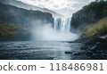 Powerful waterfall cascading down a towering rocky cliff surrounded by lush verdant foliage and swirling mist creating a captivating and serene natural scene 118486981