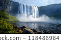 Powerful Waterfall Cascading Down Rocky Cliff Surrounded by Mist and Lush Greenery Majestic Natural Landscape with Rushing Water Scenic Outdoor Adventure and 118486984